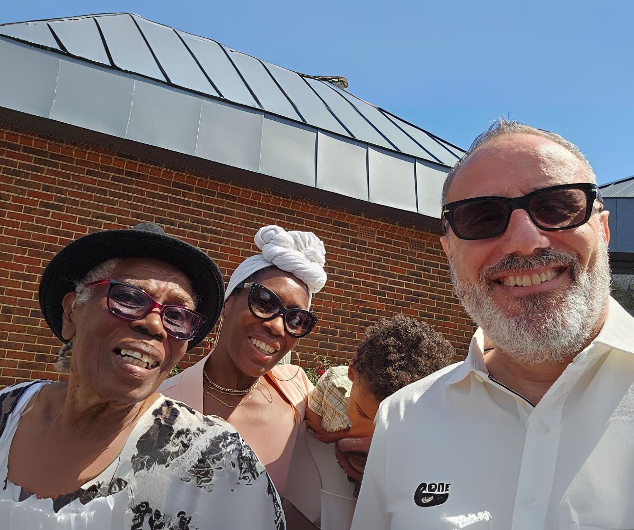 Family smiling into the camera in front of church